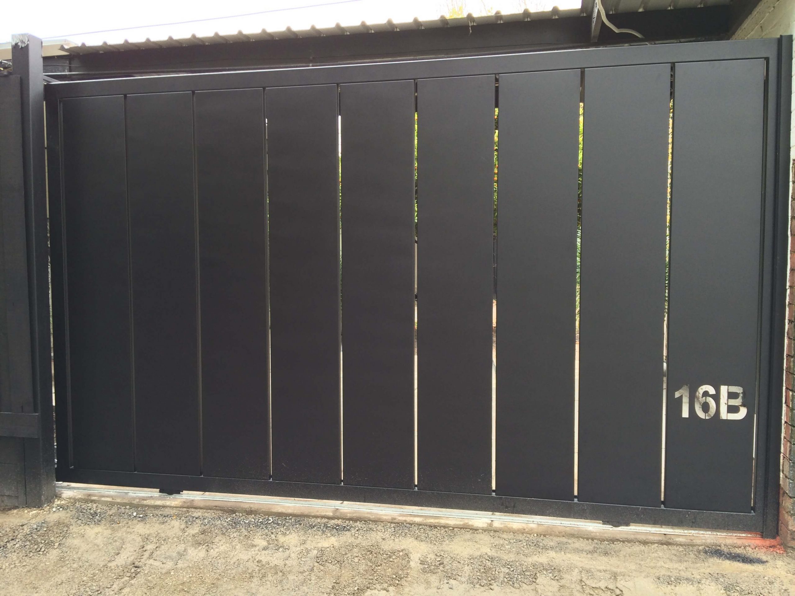 Sleek black aluminium sliding driveway gate with vertical slats in Melbourne