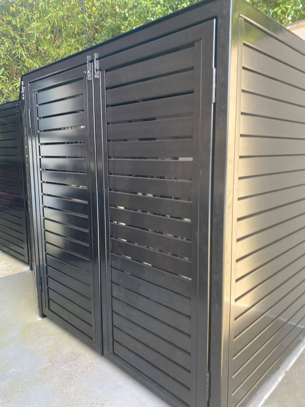 Custom black aluminium slat enclosure for wheelie bin storage and utility screening in Melbourne