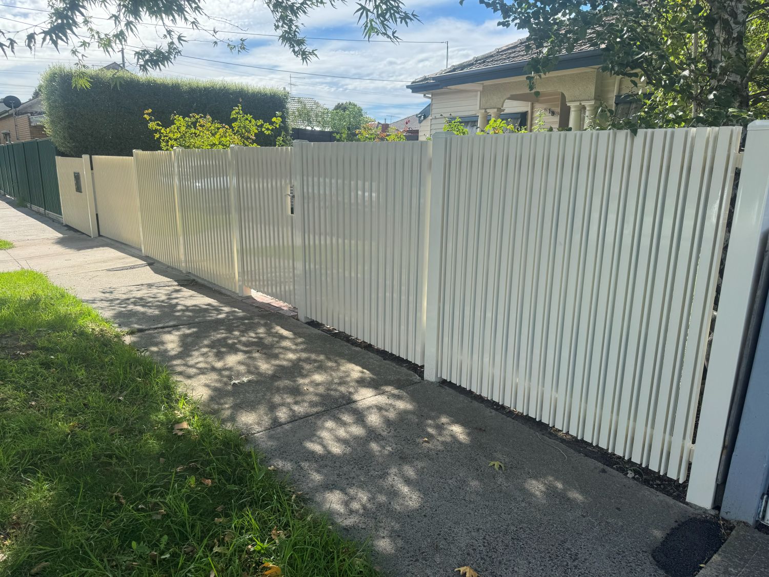 White Birch aluminium front fence with pedestrian gates and sliding driveway gate in Northcote
