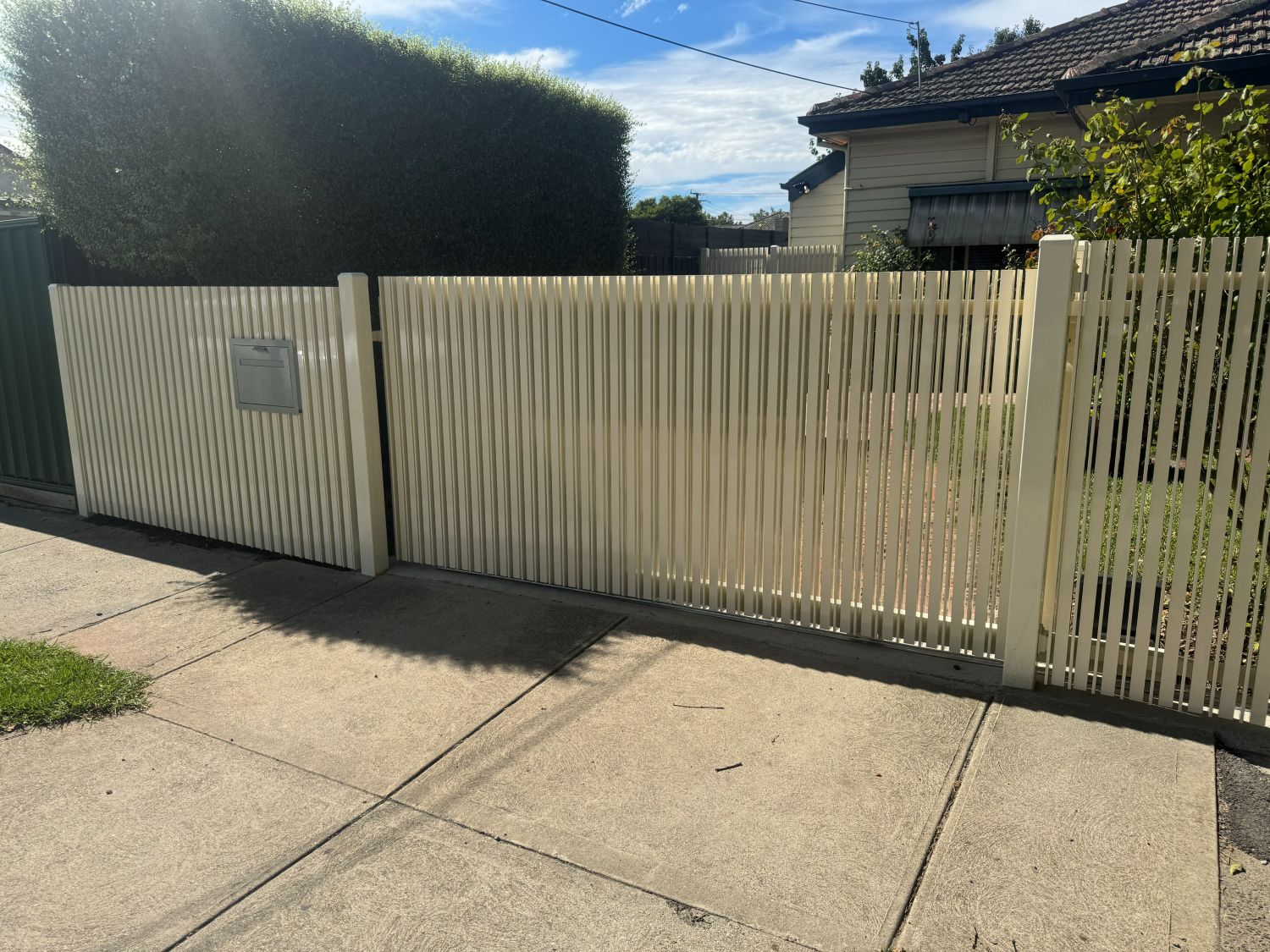 White Birch automated aluminium sliding gate with matching front fence in Northcote