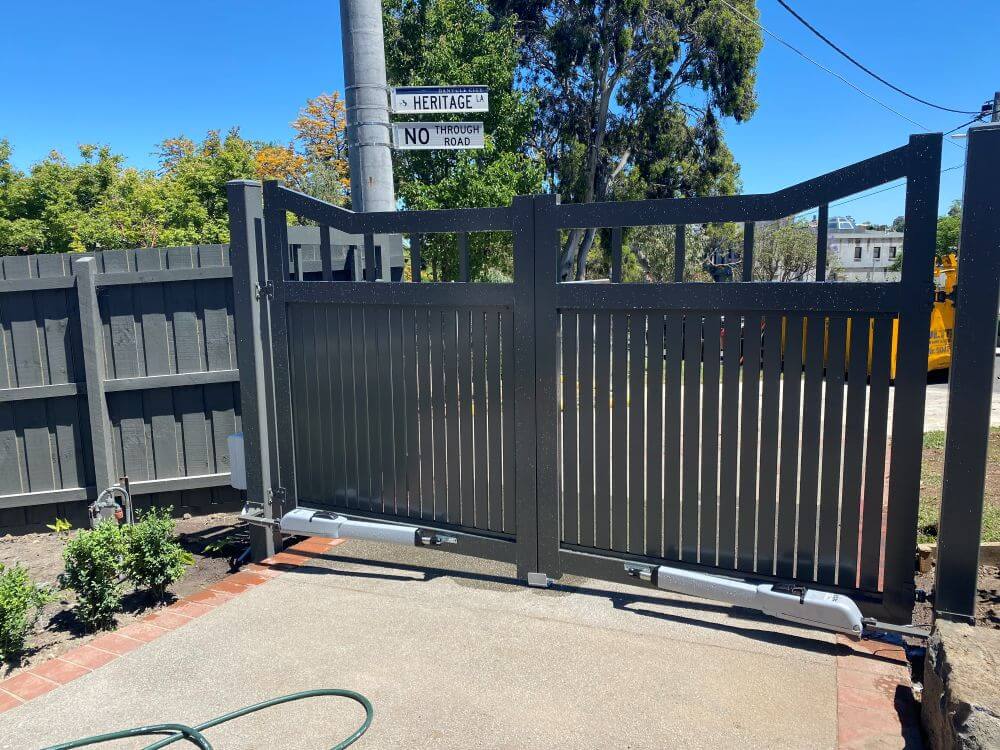 Inside property view showing automated double swing gate linear actuator motors mounted on the lower frame.